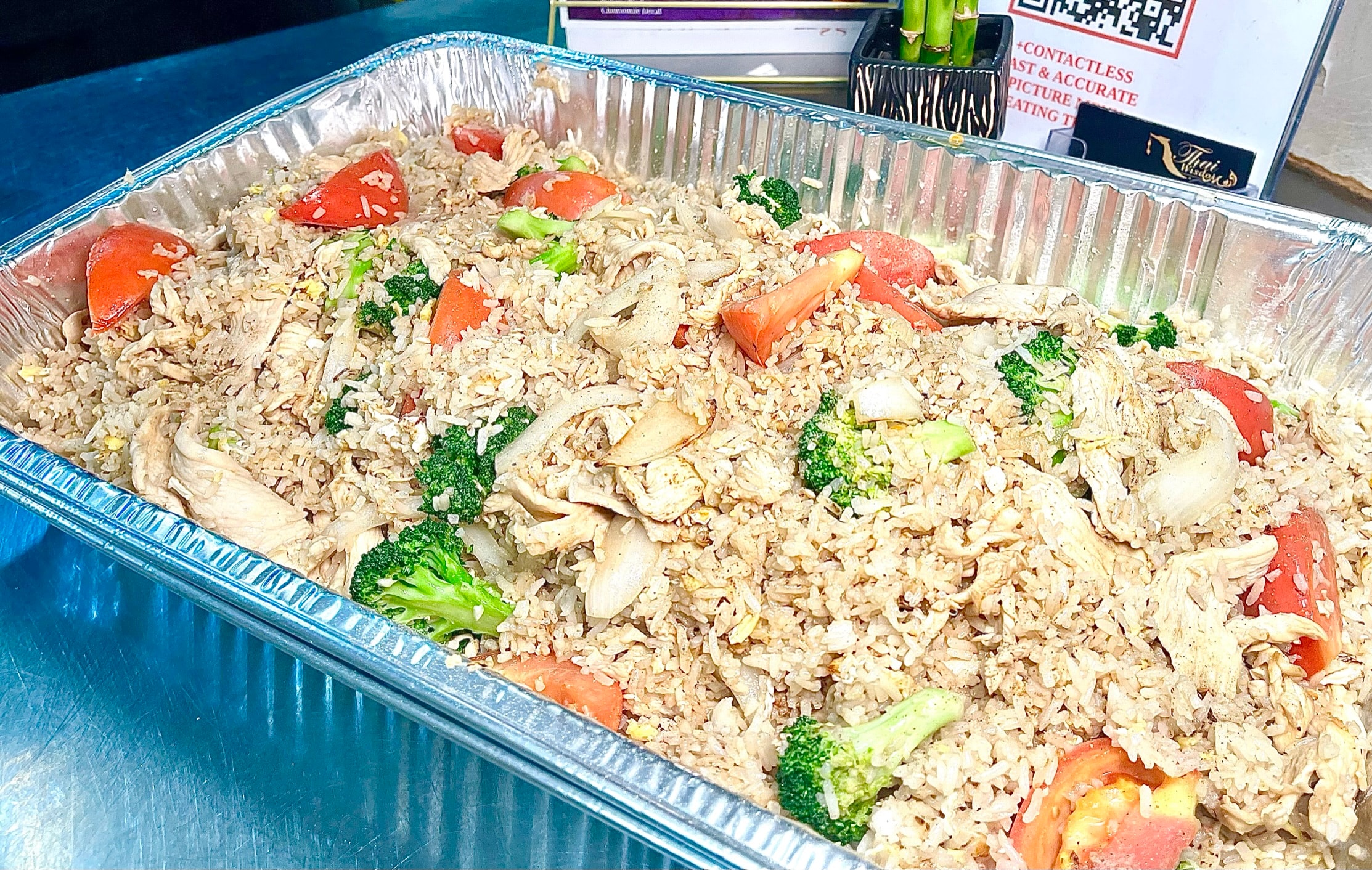 Large Thai catering tray with fried rice and assorted dishes